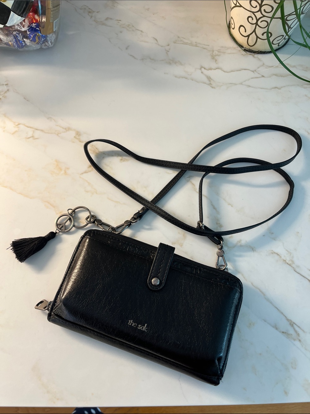 The Sak Black Leather Crossbody Wallet with Tassel and Charm